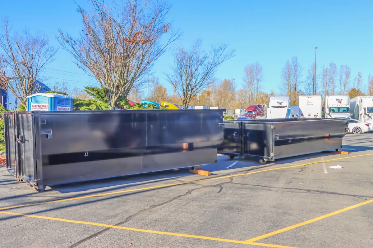 Professional dumpster rental service with roll-off container on residential driveway in Randolph